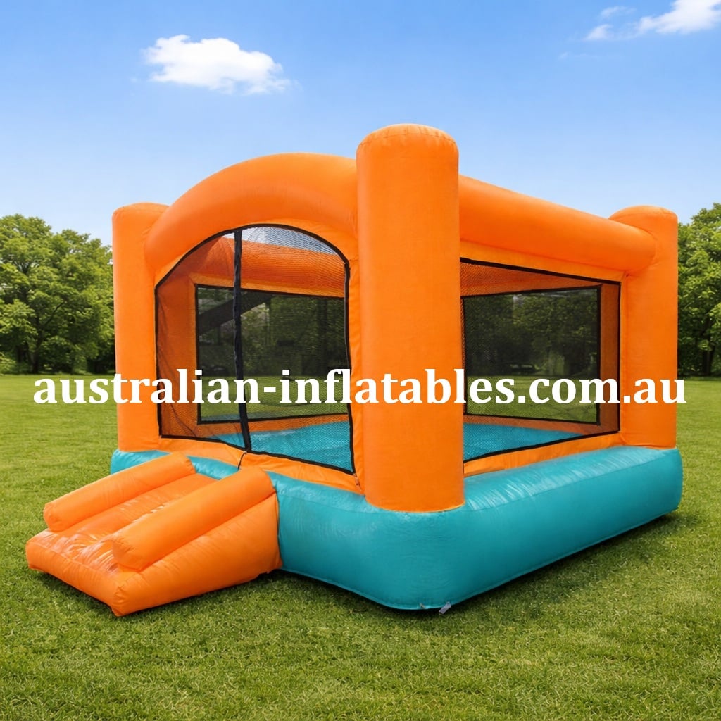 Orange and teal inflatable bounce house on a grassy field in a park